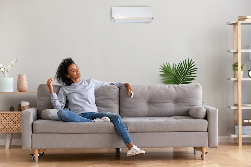 What Accessories Can Help With My Indoor Air Quality? Image of woman sitting on couch.